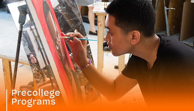 Student painting on an easle
