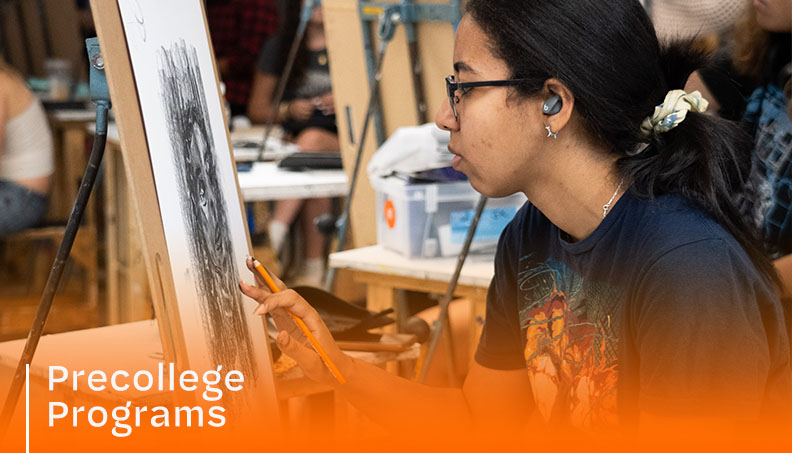 Student drawing on an easel